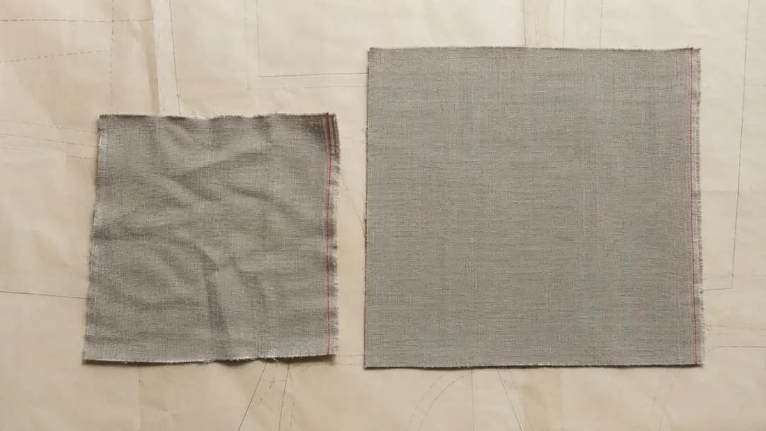 Two squares of the same linen after washing, one visibly smaller than the other.